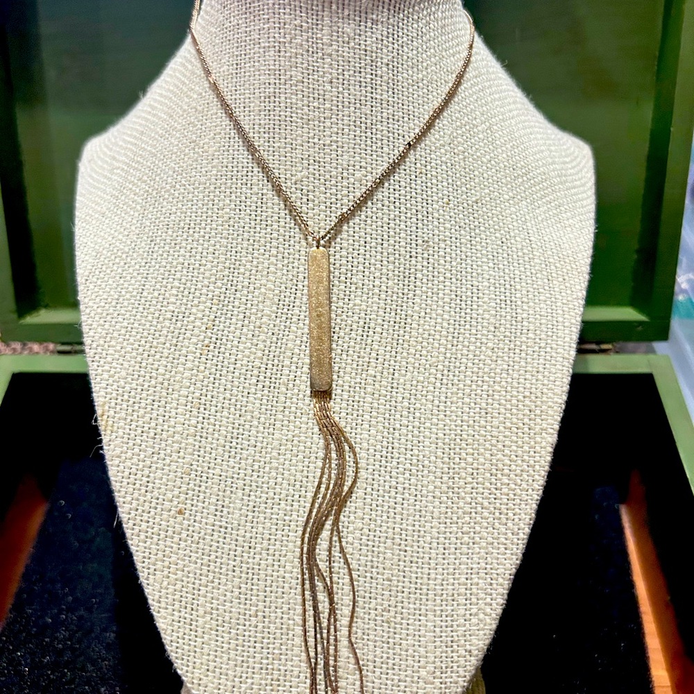 That’s pretty neat! 80’s style gold toned bar necklace.